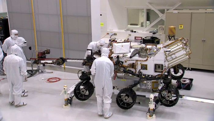 Engineers install a robotic arm onto the CURIOSITY Mars Rover at NASA's Jet Propulsion Laboratory in Pasadena, California.