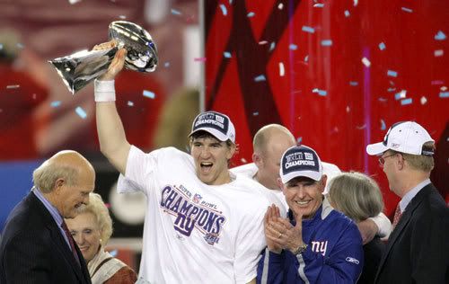 Quarterback Eli Manning holds the Vince Lombardi Trophy after the New York Giants defeat the New England Patriots, 17-14, in Super Bowl XLII on February 3, 2008.