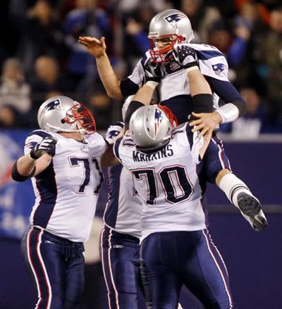 New England Patriots quarterback Tom Brady is lifted in the air by his teammates Logan Mankins (70) and Russ Hochstein, left, after Brady threw a 65-yard touchdown to Randy Moss in the third quarter of an NFL football game against the New York Giants at Giants Stadium in East Rutherford, N.J., on Saturday, Dec. 29, 2007. Brady broke the single-season record with his 50th touchdown pass and Moss broke the single season-record with his 23rd touchdown reception on the play.