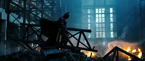 Batman stands amid a pile of wreckage.