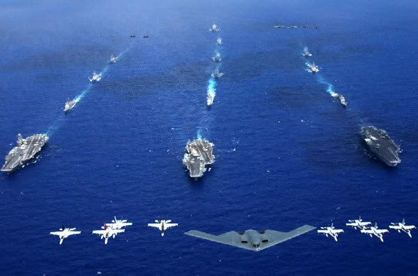 A U.S. Air Force B-2 stealth bomber and 16 other aircraft from the Air Force, Navy, and Marine Corps fly over the USS Kitty Hawk, USS Ronald Reagan, and USS Abraham Lincoln carrier strike groups during a joint photo opportunity that kicked off exercise Valiant Shield, on June 19, 2006.