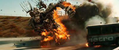 Bonecrusher obliterates a bus on a freeway as he pursues the Autobots in TRANSFORMERS.