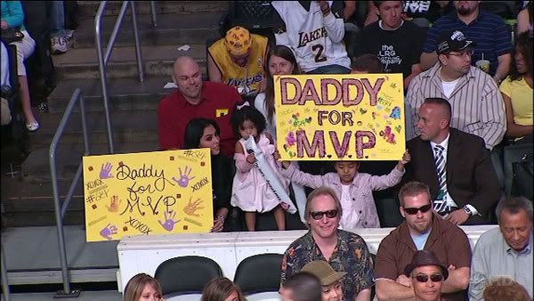 At STAPLES Center, Kobe Bryant's wife and one of their two daughters hold up 'Daddy For MVP' signs during the Lakers' game against the San Antonio Spurs on Sunday.