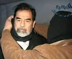 Saddam Hussein getting his hood removed by an executioner.