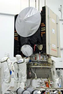 Technicians work on attaching the Dawn spacecraft to its third stage kick motor at the Astrotech facility in Florida.