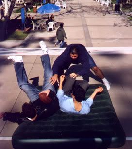 Chris and Mike falling onto a stunt mat (actually an inflatable bed used for camping) after being tackled by Tommy.