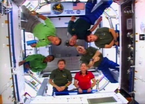 The crew of shuttle mission STS-120 gather inside the Harmony module a day after it was attached to the International Space Station.