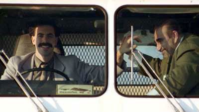 Borat and his producer/wrestling-partner Azamat high-five in their $600 ice cream truck.