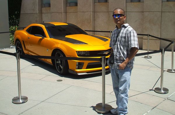 Posing in front of the Chevy Camaro that represents Bumblebee in TRANSFORMERS 3.