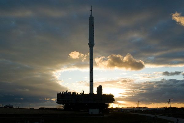 The ARES I-X rocket rolls toward Launch Complex 39B at NASA's Kennedy Space Center in Florida, as the Sun rises on October 20, 2009.