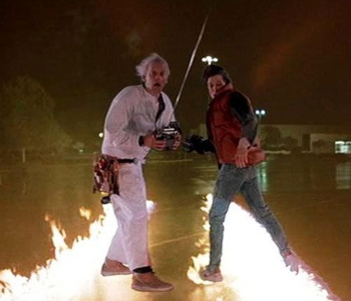 Outside the Twin Pines Mall, Doc Brown and Marty McFly stare at the after-effects of the DeLorean traveling back in time in BACK TO THE FUTURE.