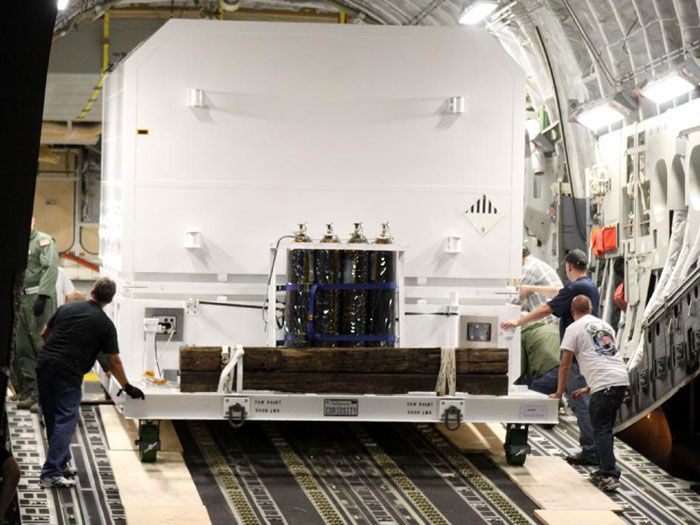 A crate carrying the CURIOSITY Mars Rover is unloaded from the C-17 aircraft that flew it from California to Kennedy Space Center in Florida, on June 22, 2011.