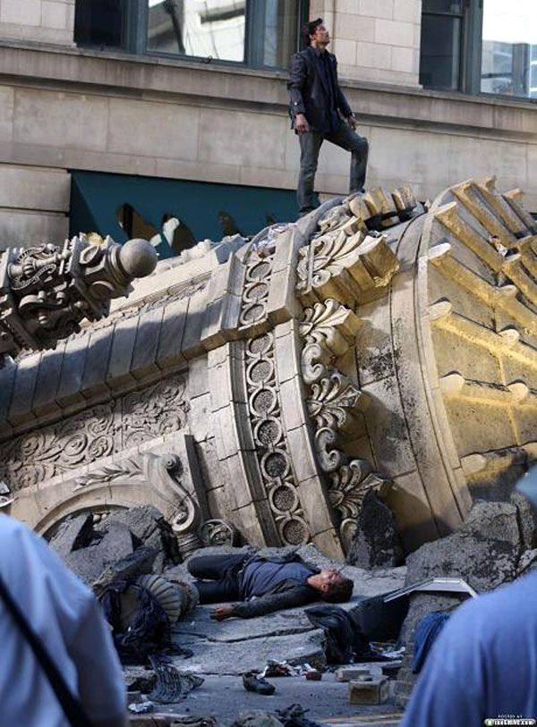 Shia LaBeouf lies unconscious on rubble as Patrick Dempsey stands triumphantly above him during filming of TRANSFORMERS 3.