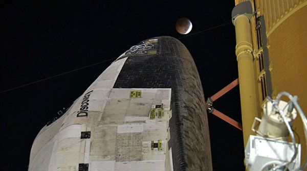 A total lunar eclipse is about to take place above space shuttle Discovery on the night of December 20, 2010.