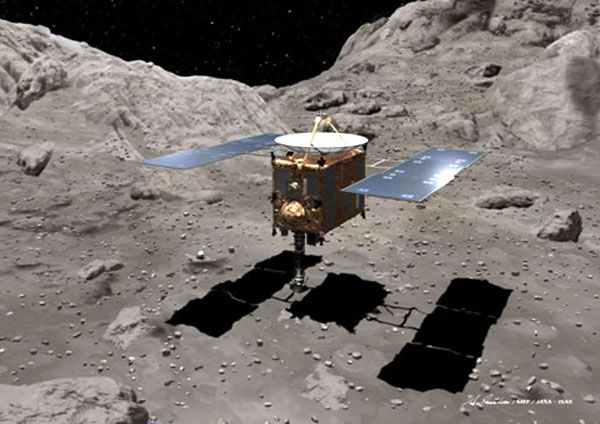 An artist concept showing the HAYABUSA spacecraft collecting rock samples from the surface of asteroid Itokawa.