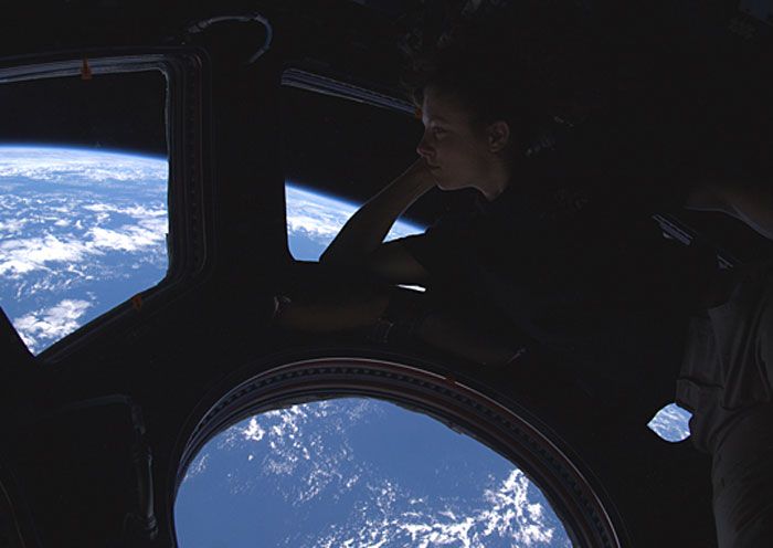 Astronaut Tracy Caldwell Dyson gazes through the Cupola window at Earth in late September of 2010.