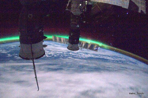 With Russian-made Progress and Soyuz vehicles in the foreground, the ISS flies away from an aurora, on April 2, 2010.