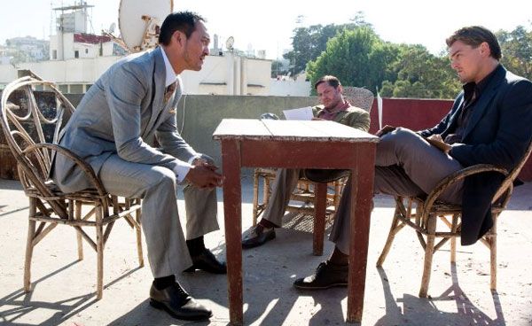 Saito discusses a new corporate espionage scheme with Cobb and Eames (Tom Hardy) in INCEPTION.