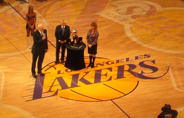 With a Laker Girl, Jeanie Buss and NBA commissioner David Stern looking on, Lakers head coach Phil Jackson addresses the STAPLES Center crowd during the ring ceremony, on October 26, 2010.
