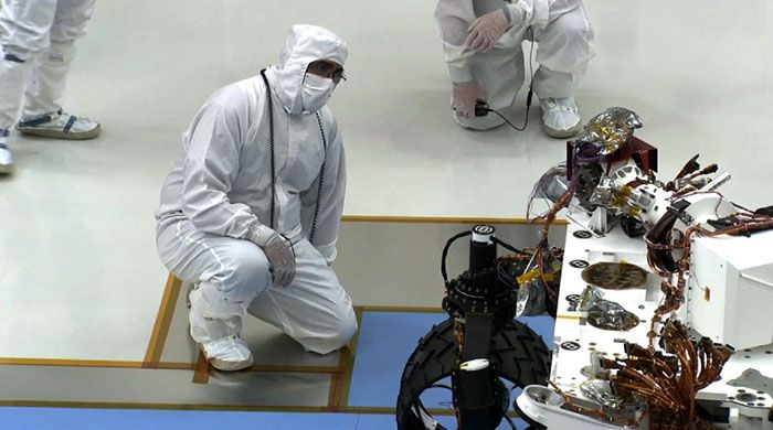 A JPL engineer looks on as the CURIOSITY Mars Rover is driven for the first time on July 23, 2010.