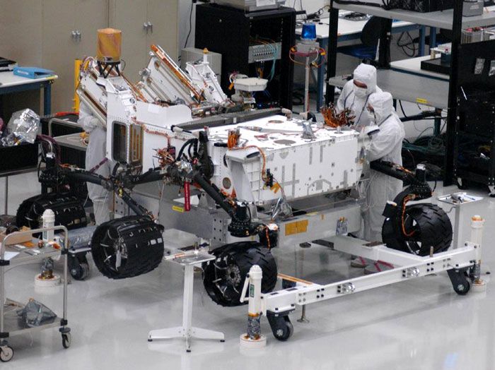 NASA JPL engineers install six wheels onto the CURIOSITY Mars Rover on June 28 and 29, 2010.