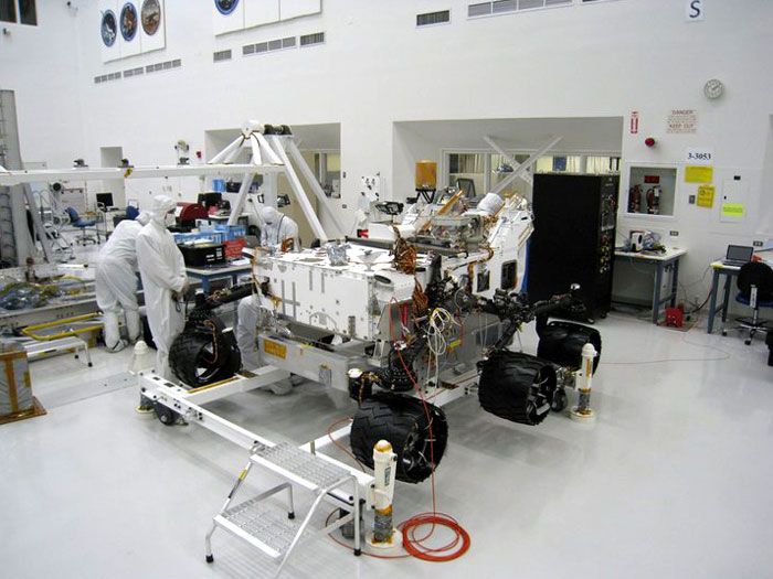 NASA JPL engineers install six wheels onto the CURIOSITY Mars Rover on June 28 and 29, 2010.