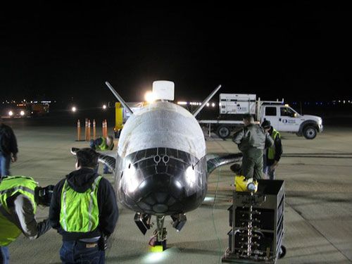 Military personnel at Vandenberg Air Force Base, California, conduct a post-landing checkout on the OTV after its return home from space on December 3, 2010.