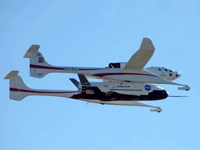 Attached to a Scaled Composites' White Knight aircraft, the OTV undergoes a flight test in this NASA file photo.