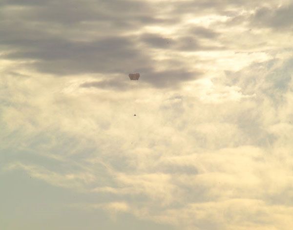 Parachutes deploy on the mock-up Orion spacecraft after it successfully separates from the launch abort system during the PA-1 test.