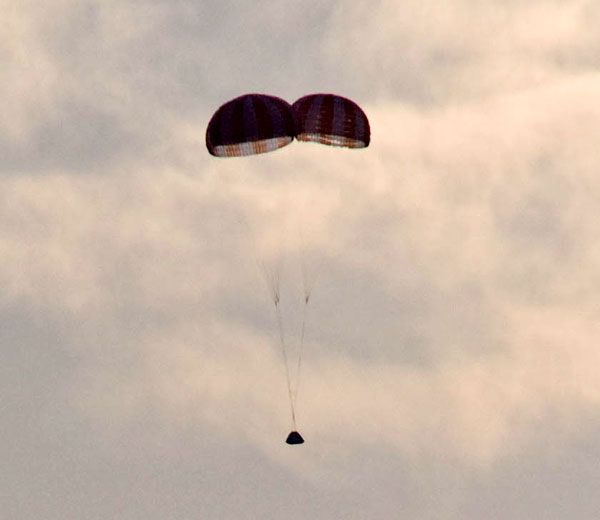 Parachutes deploy on the mock-up Orion spacecraft after it successfully separates from the launch abort system during the PA-1 test.