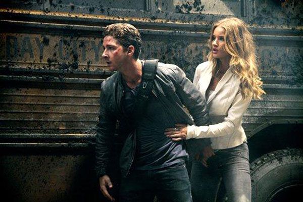 Shia LaBeouf and Rosie Huntington-Whiteley watch out for danger in TRANSFORMERS: DARK OF THE MOON.