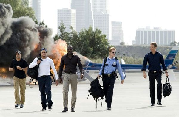 T.I., Michael Ealy, Idris Elba, Hayden Christensen and Paul Walker emerge unscathed from a bank robbery at the beginning of TAKERS.