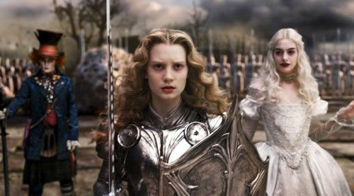 The Mad Hatter and the White Queen (Anne Hathaway) watch as Alice marches off to battle in ALICE IN WONDERLAND.