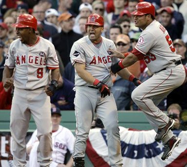 Los Angeles Angels' Bobby Abreu, right, celebrates with teammates Chone Figgins (9) and Kendry Morales, center, after scoring in the 9th inning against the Boston Red Sox during Game 3 of an American League baseball division series in Boston, on Sunday, Oct. 11, 2009.  The Angels won, 7-6.