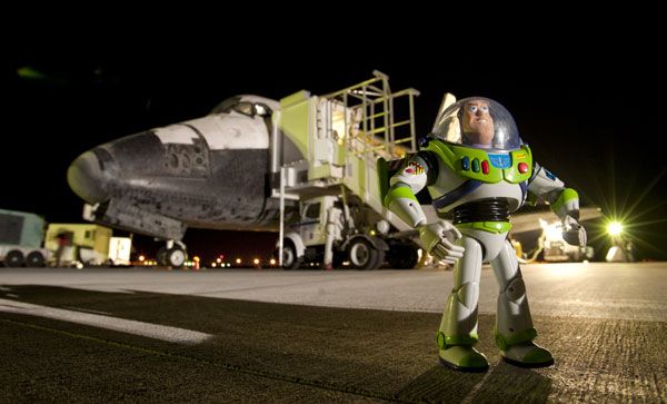 Buzz Lightyear poses proudly in front of the space shuttle Discovery, which took him home on September 11, 2009.