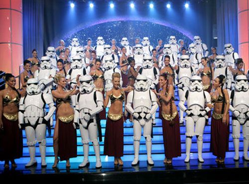 Stormtroopers and a throng of Slave Girl Leias pose on the set of DEAL OR NO DEAL.