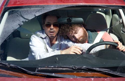 Peter Highman (Robert Downey Jr.) tries to avert disaster as Ethan Tremblay (Zach Galifianakis) snoozes in DUE DATE.