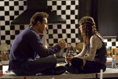 John Cusack and Lizzy Caplan share a moment in HOT TUB TIME MACHINE.