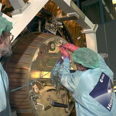A European Space Agency technician installs a CD bearing the names of 100,000 folks onto the Huygens probe, prior to launch on October 15, 1997.