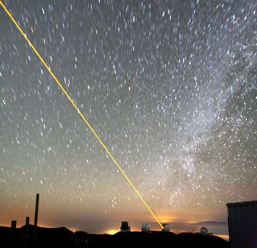 A laser shoots into the sky from one of the Keck telescopes on Mauna Kea.