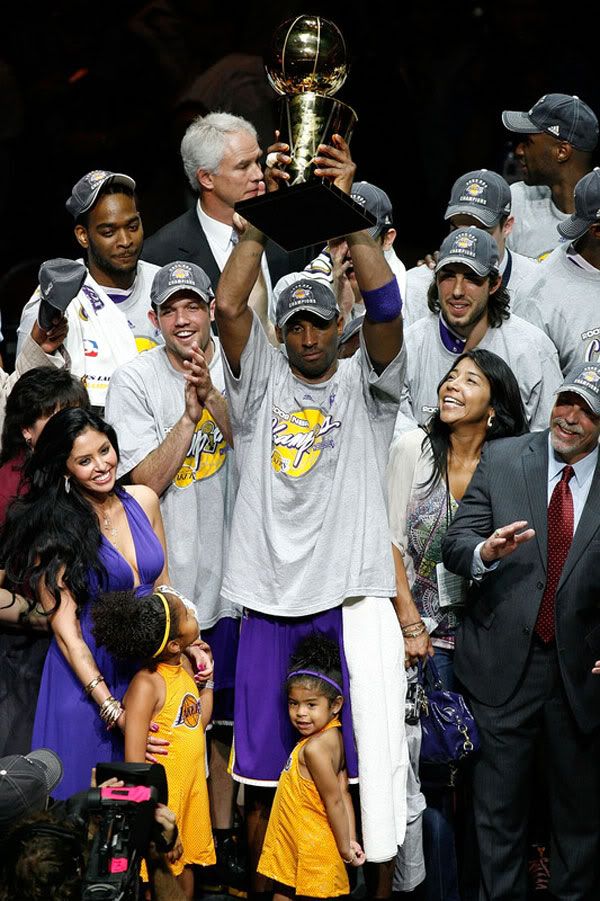As his wife and two daughters stand nearby, Kobe Bryant hoists up the NBA championship trophy after he leads the Los Angeles Lakers to its 15th title, on June 14, 2009.