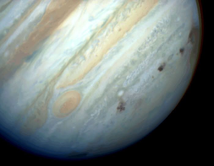 Brown spots mark the impact sites of Comet Shoemaker Levy-9 after its fragments collided with Jupiter, between July 16-22, 1994.