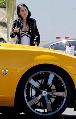 Megan Fox poses with the 2011 Chevy Camaro that will be the vehicle mode for BUMBLEBEE in Transformers 3.
