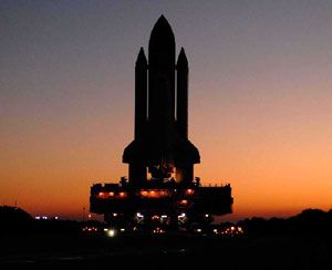 A silhouette of the space shuttle as it rolls out to its launch pad at Kennedy Space Center in Florida.