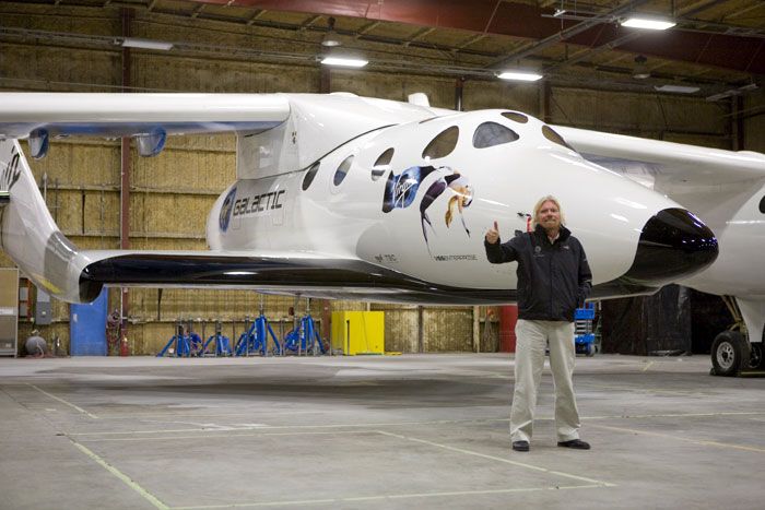 Virgin Galactic owner Sir Richard Branson poses in front of SpaceShipTwo.