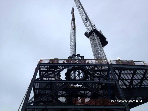 The first segment of the antenna spire is about to be lowered through the middle of the scaffolding atop the roof of 1 WTC, on January 15, 2013.