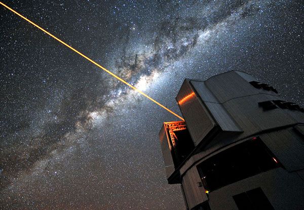 With the Milky Way overhead, a laser shoots out from the Very Large Telescope as part of its adaptive optics system.