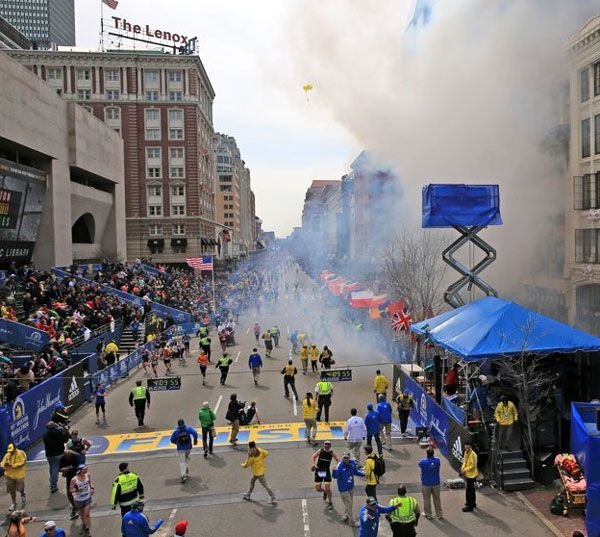 Hundreds of spectators flee after an explosion takes place at the Boston Marathon on April 15, 2013.