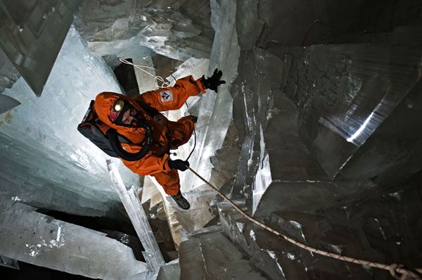 Clad in a protective ice-cooled jumpsuit, a researcher rappels his way into the Cave of Crystals...whose interior can get as hot as 112°F.
