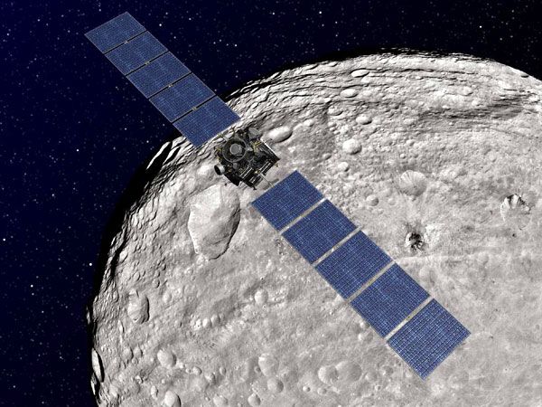 An artist's concept of the Dawn spacecraft orbiting asteroid Vesta.